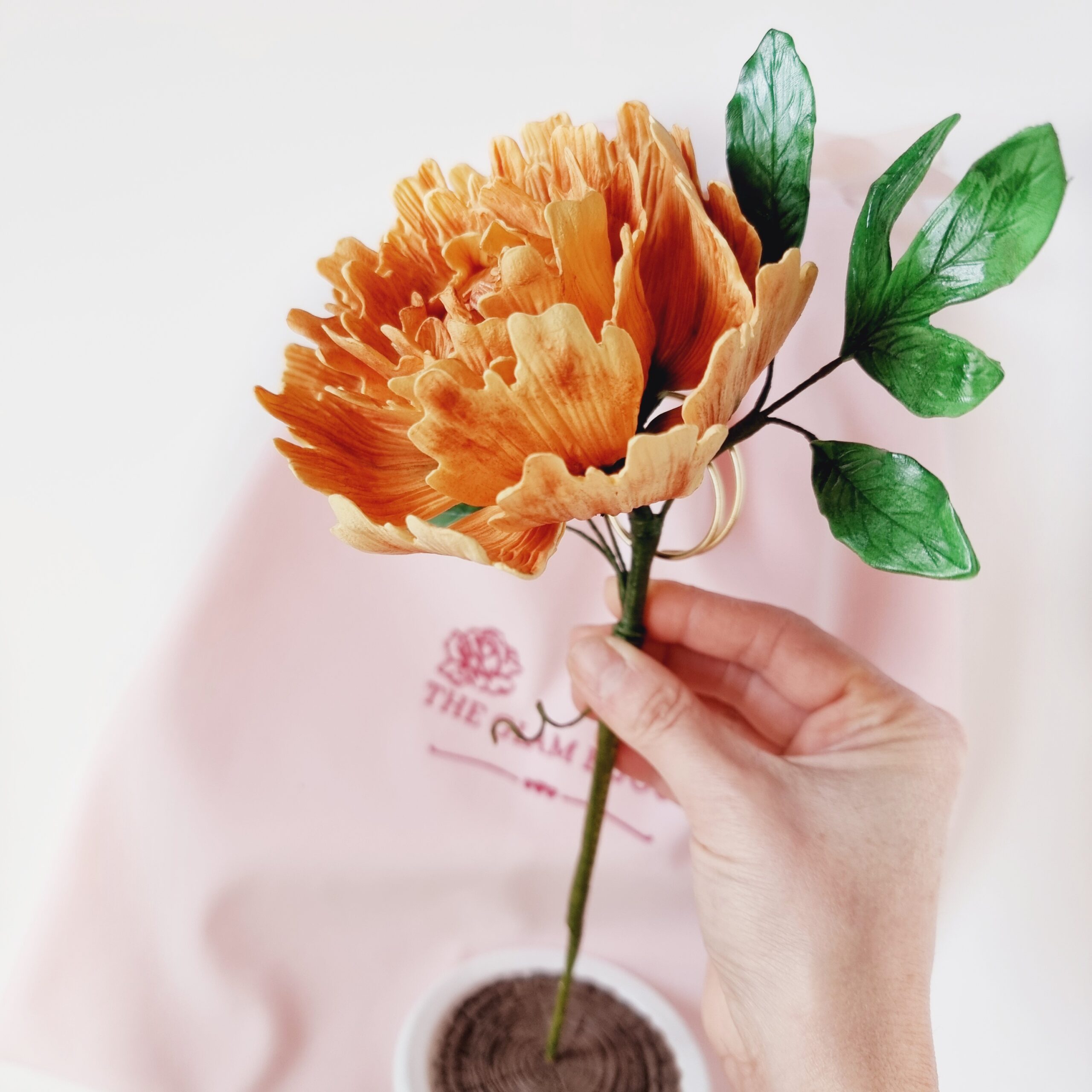 Handcrafted clay peony flower in a glass holder, a unique gift for any occasion