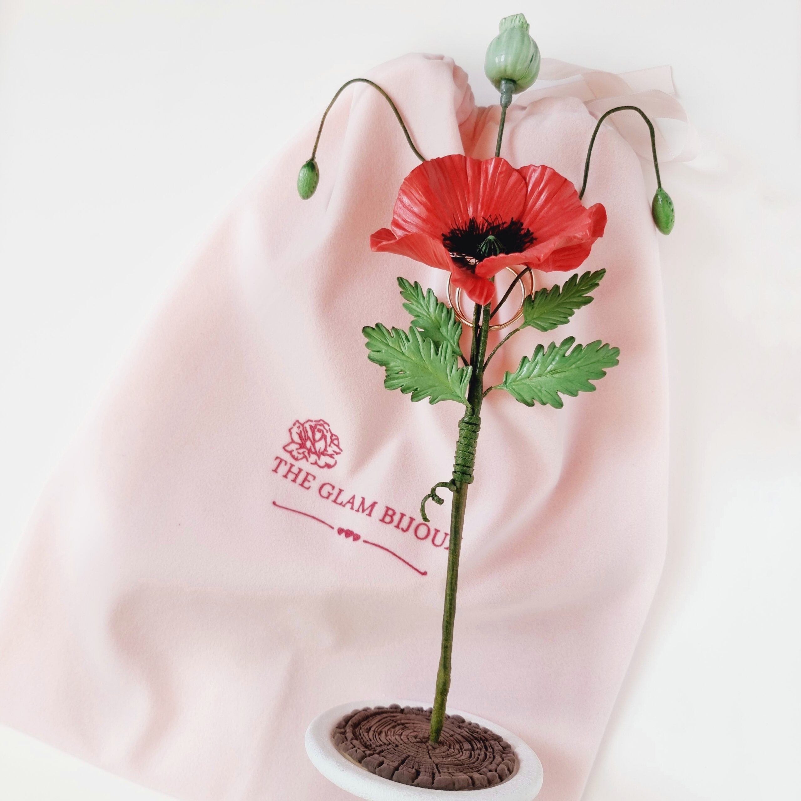 Handcrafted red poppy flower with a sleek, minimalist holder, showcasing timeless elegance and lasting beauty