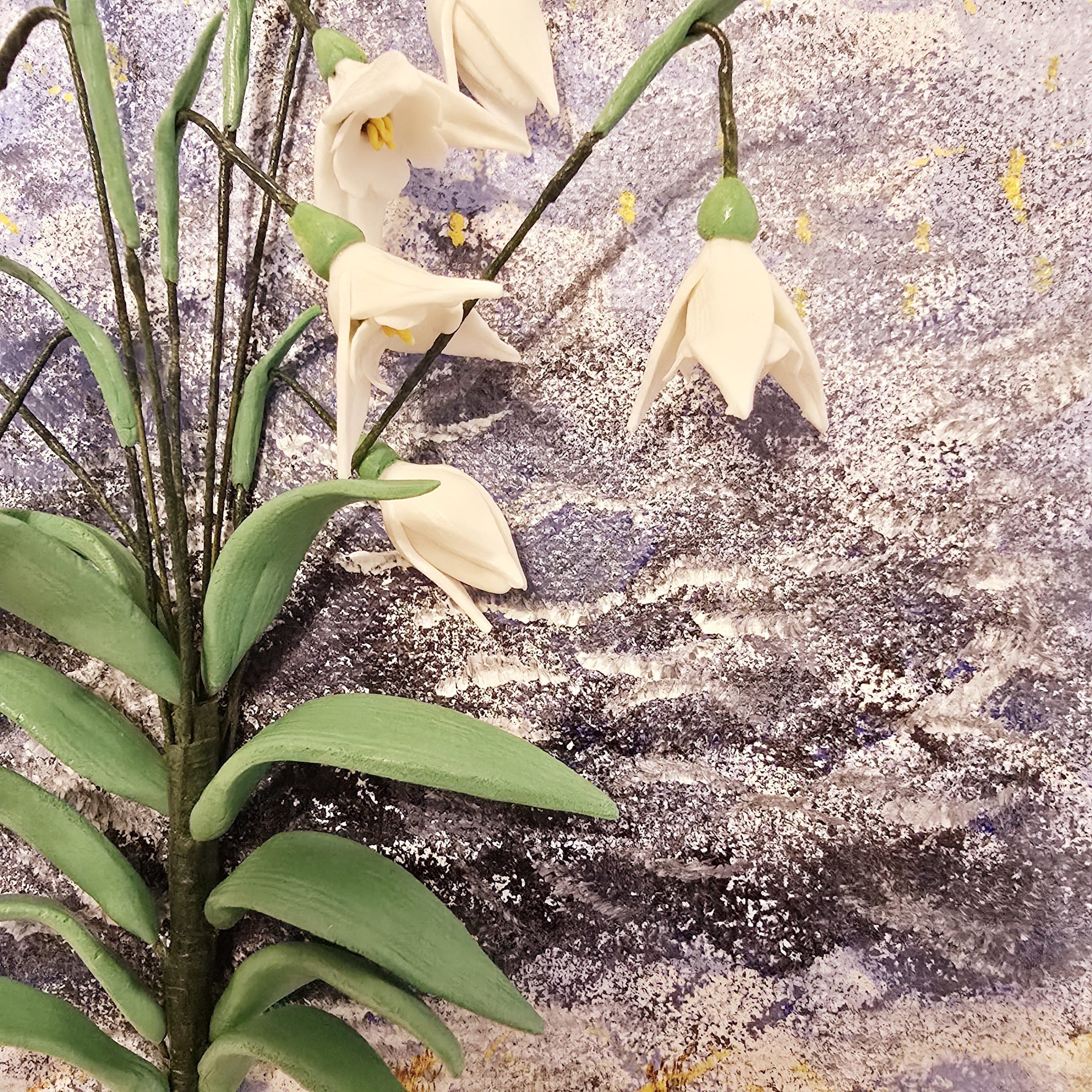 Close-up of handcrafted clay snowdrops with intricate details.