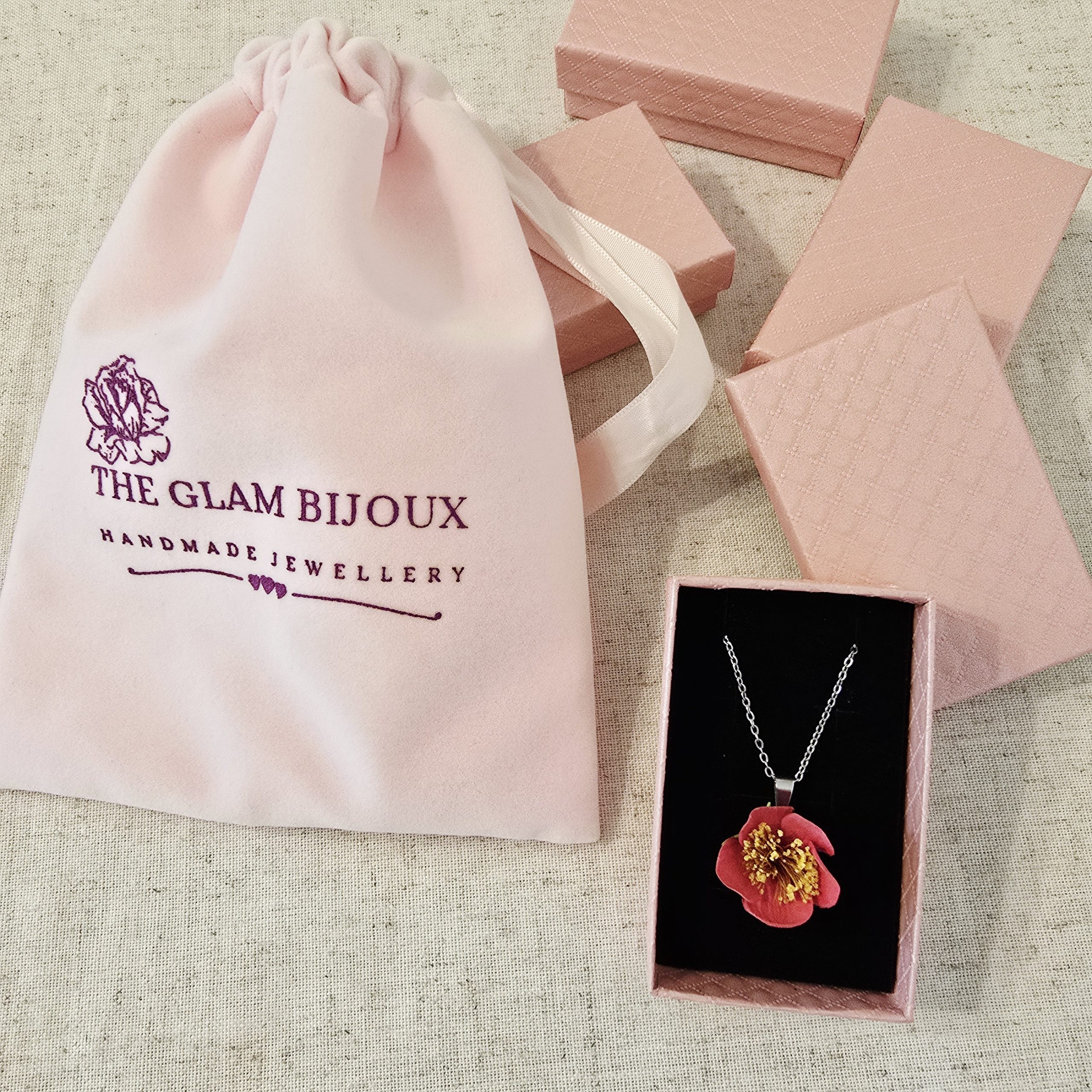 Camellia Necklace by The Glam Bijoux showcased in soft pink packaging with velvet pouch.