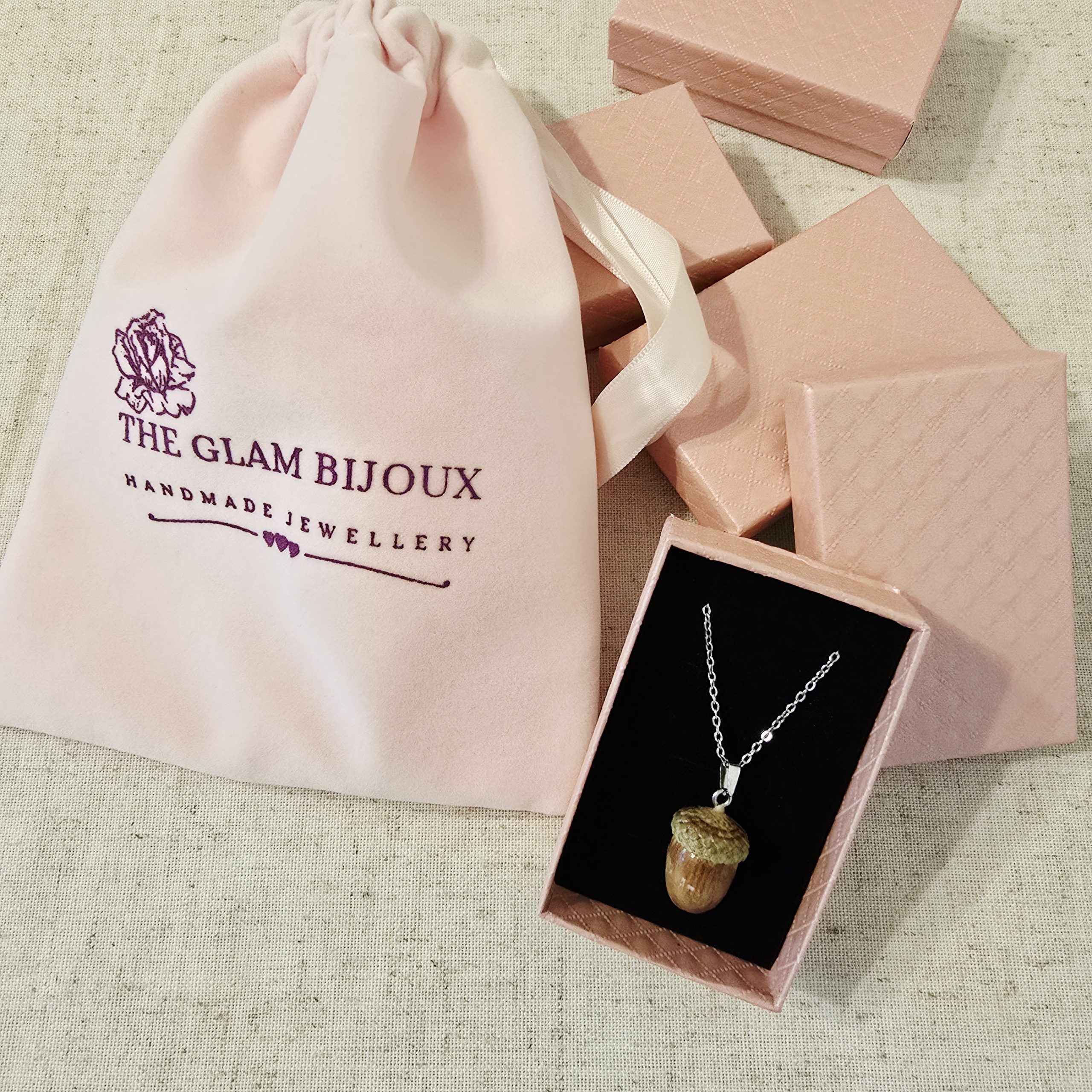 Acorn Necklace by The Glam Bijoux inside pink gift box and branded pink velvet pouch.