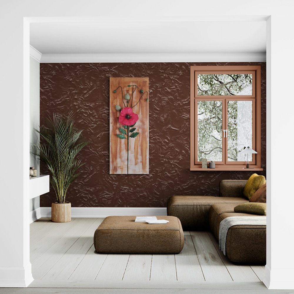 Vertical clay poppy artwork in a cozy corner with neutral tones and a white wall backdrop